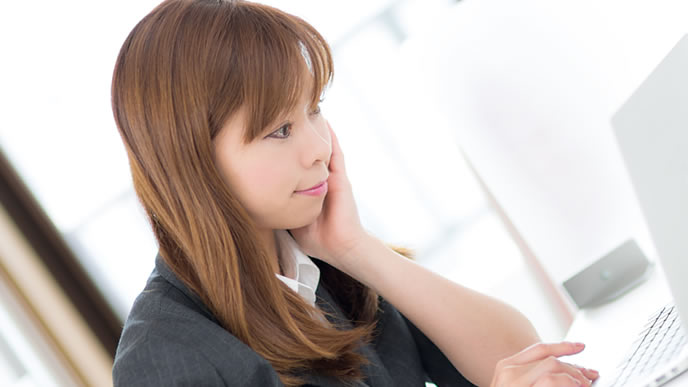 退職願の縦書きか横書きかを調べている女性