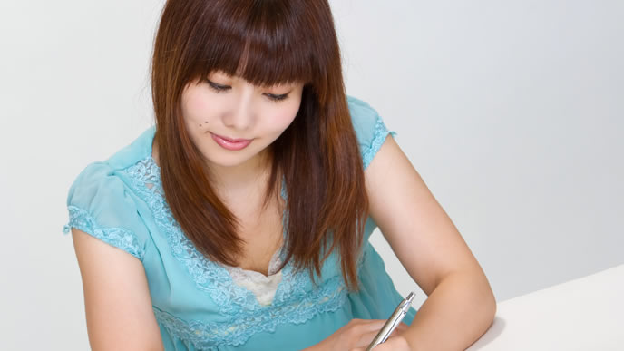 お世話になった方に手紙を書く女性