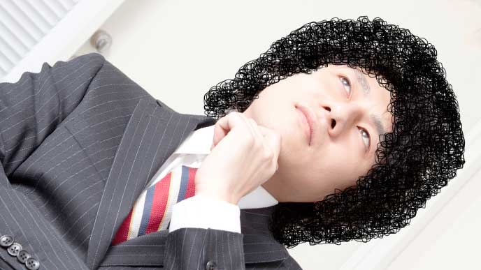 髪型について考えている男性社員
