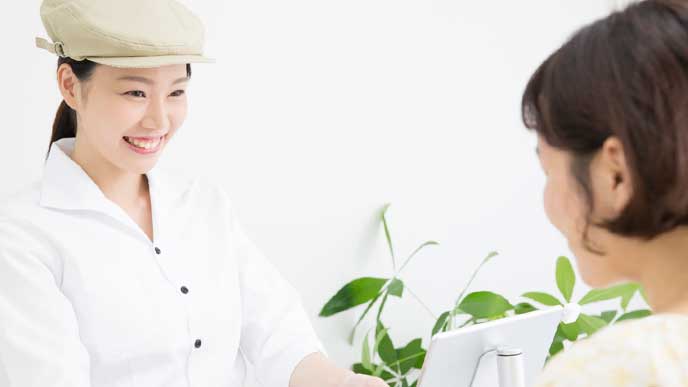 お客様の会計をレジで処理するカフェ店員のアルバイト