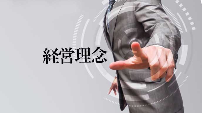 指を指すスーツを着た男性