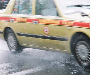 雨の中を走るタクシー