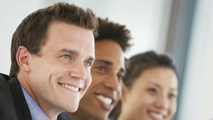 会議の席でポジティブな態度で話を聞く男性